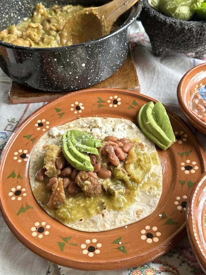 chicharron taco with beans and avocado