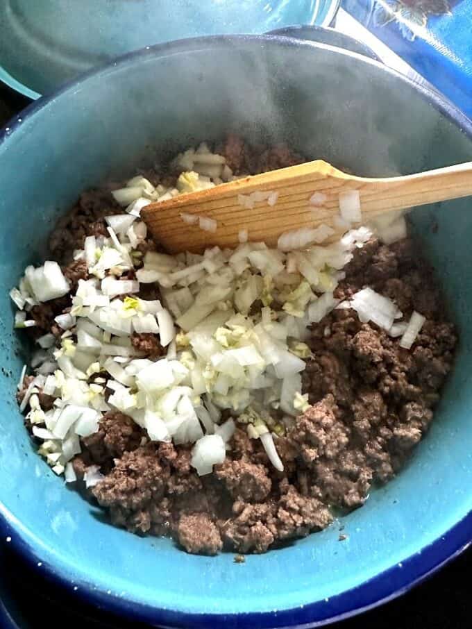 adding onion and garlic to beef