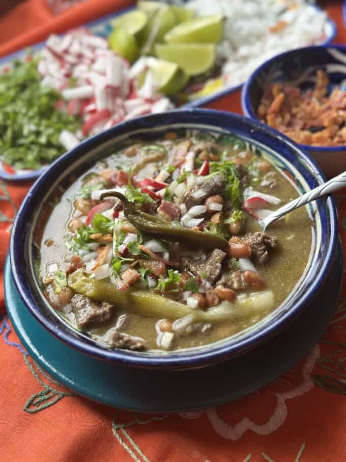 carne en su jugo plated in a shallow bowl with garnishes