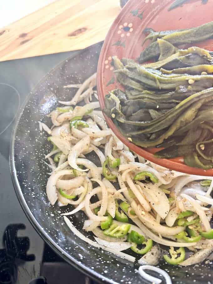 adding rajas to the skillet