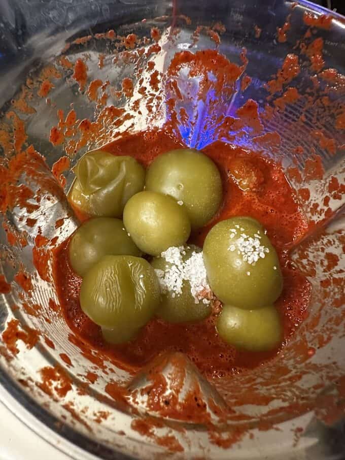 tomatillos and salt added to the blender