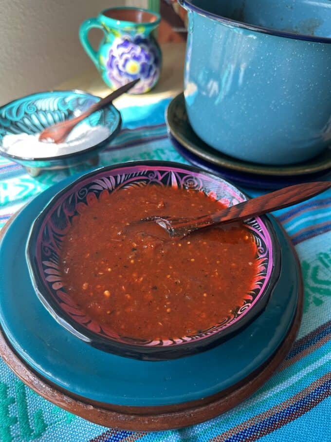 red salsa in a bowl with small spoon