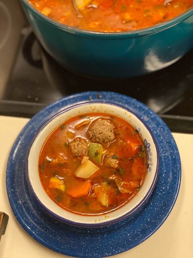 meatball soup in bowl near the stove top