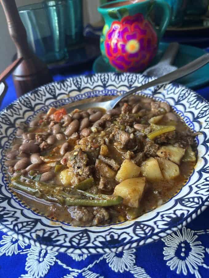 plated in a shallow bowl, bistec ranchero with charro beans
