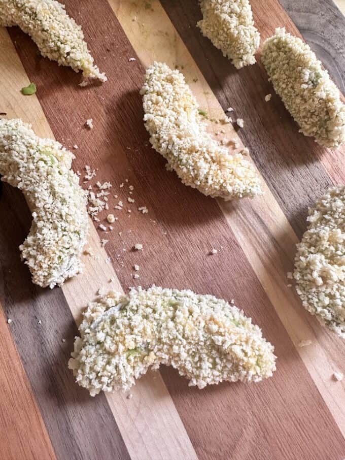 avocado wedges covered in panko before frying