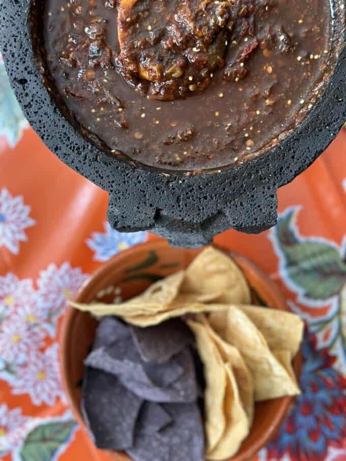 salsa negra in molcajete with chips