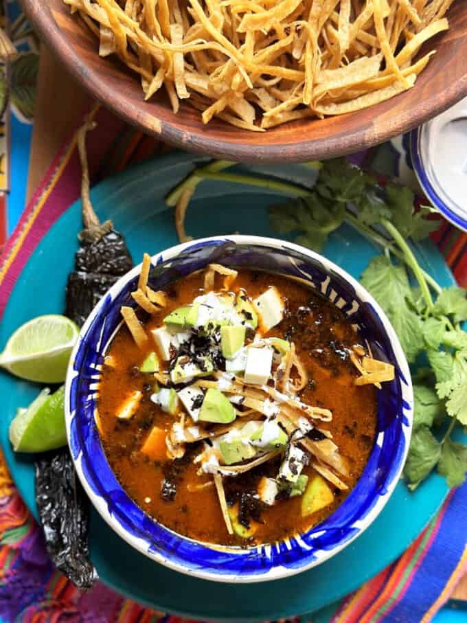 tortilla soup plated with dried strips