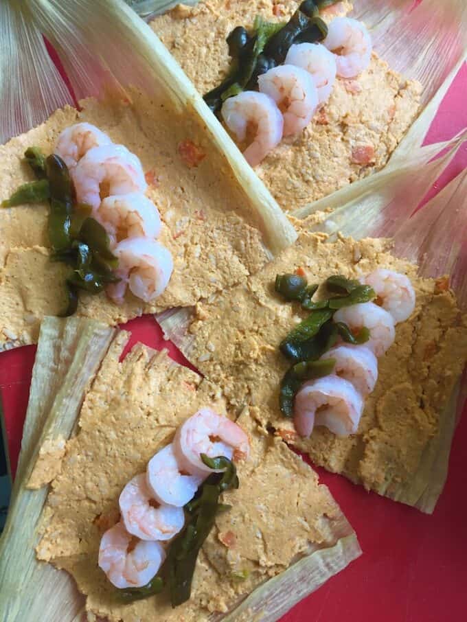 adding roasted poblanos with shrimp