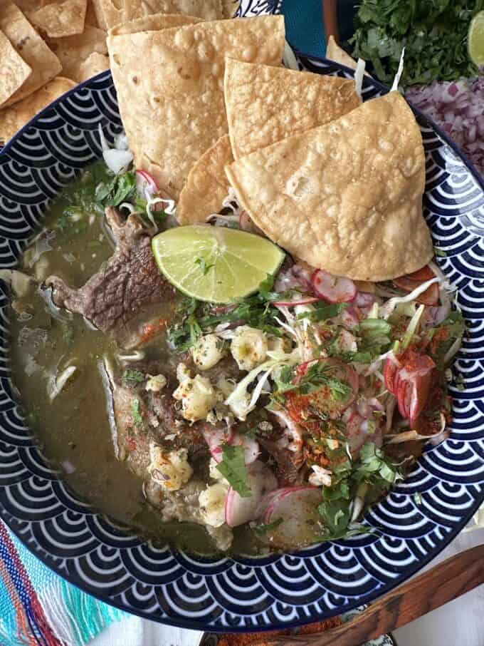 top view of beef pozole plated with all the garnish