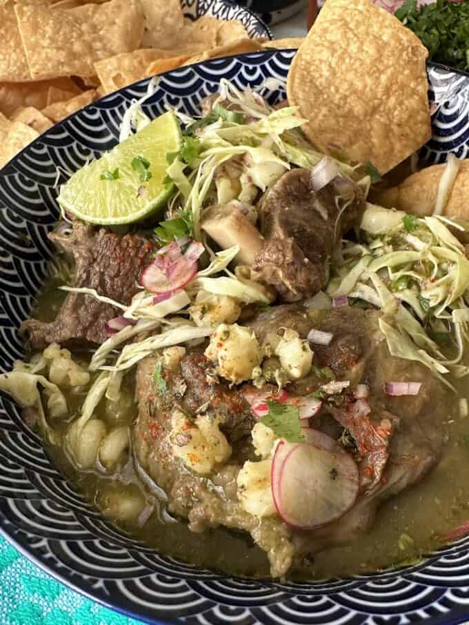 beef pozole plated with all the garnishes
