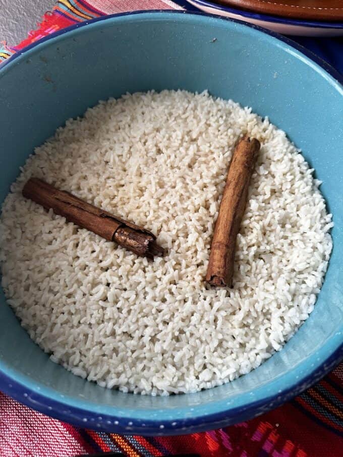 Cooked rice in the pot with cinnamon sticks