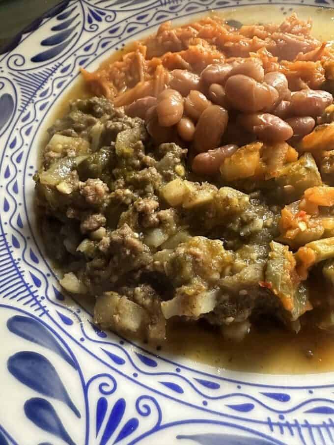 picadillo plated with beans and fideo