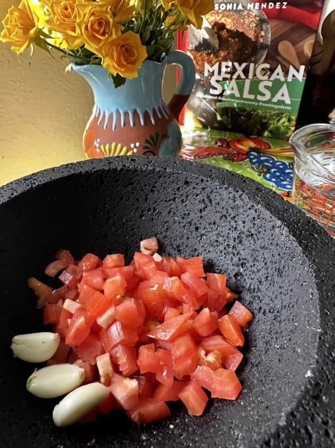 diced tomato and garlic in the molcajete